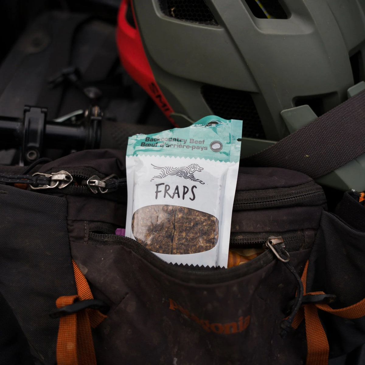 Fraps Backcountry Beef Breakable Dog Treat Bar in a hiking backpack
